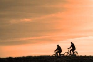 cyclists at sunset